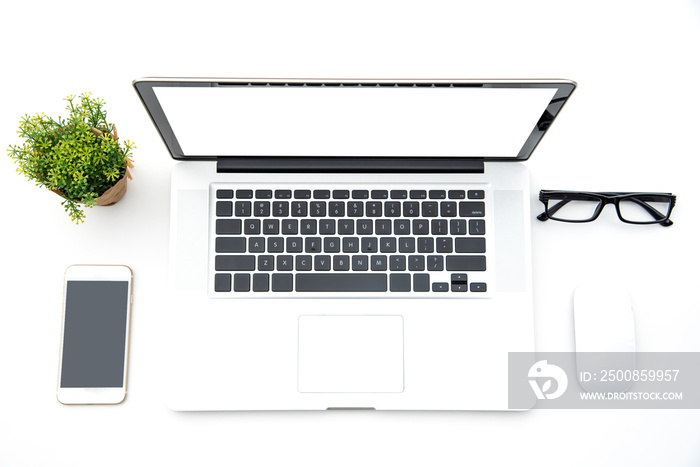 Top view with working desk with laptop,cellphone,notebook pencil coffee cup and eyeglasses in the office.