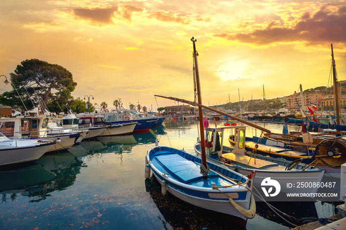 Landscape with fishing boats in harbour of Cassis at sunset. France, Provence