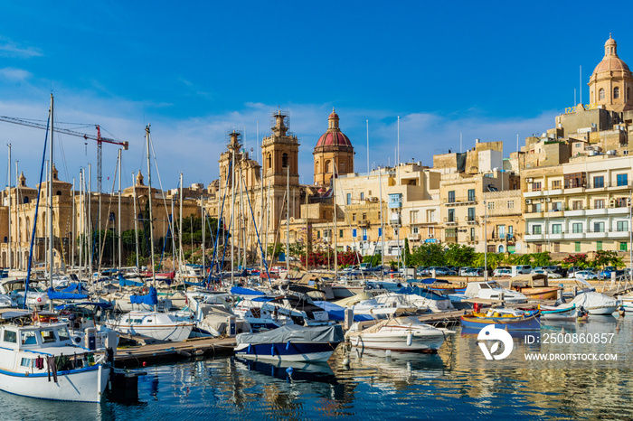 Boats in Vittoriosa Marina in Birgu, Malta with Saint Lawrence’s Church in the background.