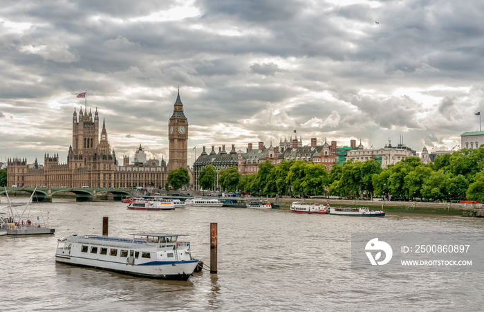 London - view of Big Ben clock tower, Houses of Parliament and Thames river with boats, United Kingdom.