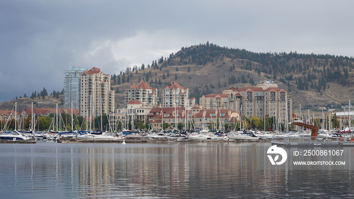 Buildings reflecting in the calm lake at Kelowna city in British Colombia, Canada.