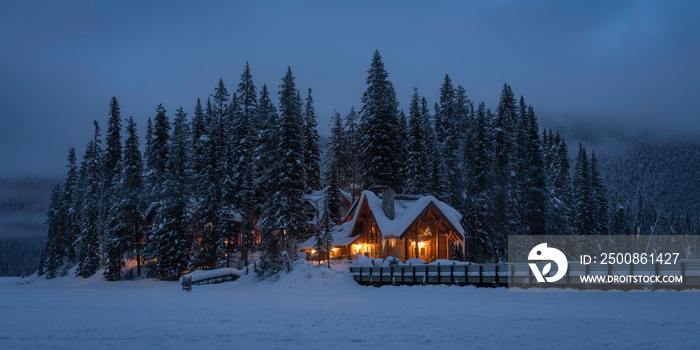 Morning twilight at the iconic Emerald Lake Lodge of Yoho National Park with the Cilantro Cafe glowing in the icy dawn.