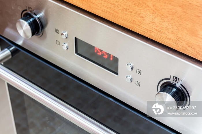 Stainless steel oven detail showing the knobs and door