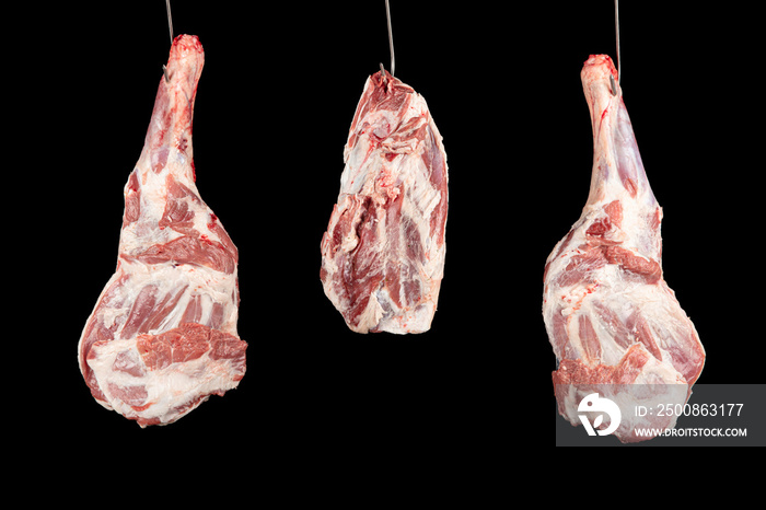 Raw lamb leg on black background. Fresh and raw meat. Uncooked leg of lamb on black background. Grilled meat and barbecue concept.