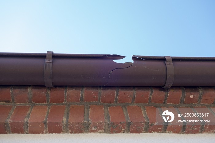 Broken guttering on the roof of a house