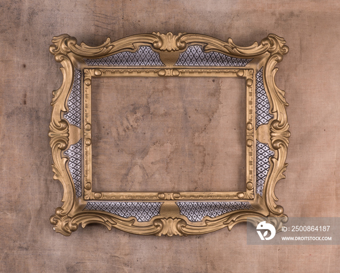 elegant vintage victorian frame on an old dirty brown wall