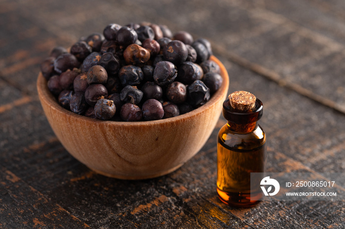 Juniper Berry Essential Oil on a Distressed Wooden Table