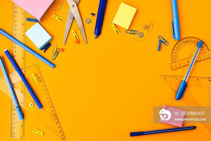 School supplies on yellow background, copy space, scissors, pen, paper clips, ruller, stickers. Back to school