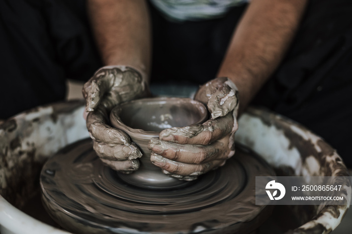 Hands of craftsman artist working on pottery wheel.Selective Focus .