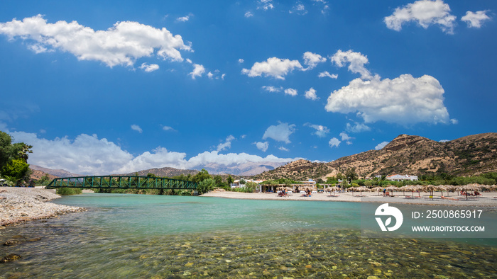 Agia Galini Beach in Crete island, Greece. Tourists relax and bath in crystal clear water of Agia Galini Beach.