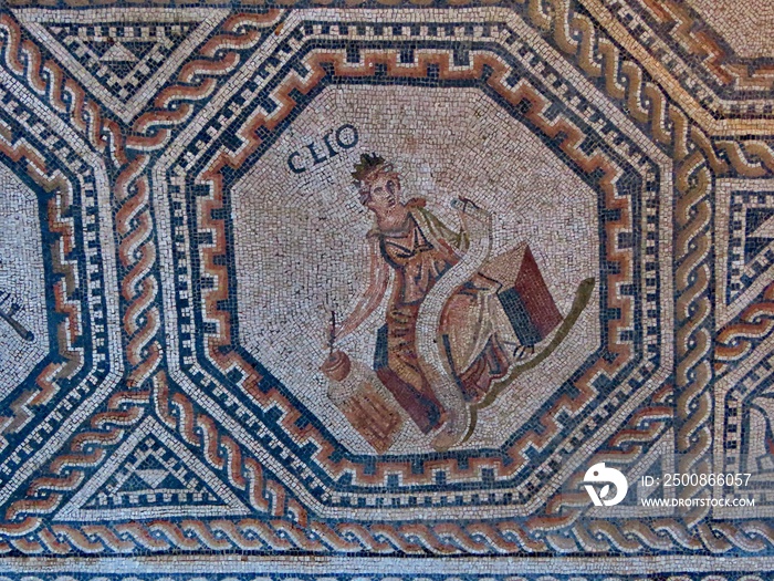 Clio - one of 9 muses portrayed in medalion with geometric ornamented borders. The Roman floor mosaic is freely accessible for everybody outdoors in Vitchen, Luxembourg