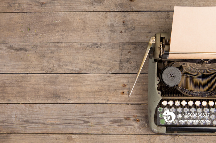 Vintage typewriter on the old wooden desk