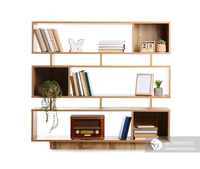 Shelving unit with books and decor on white background