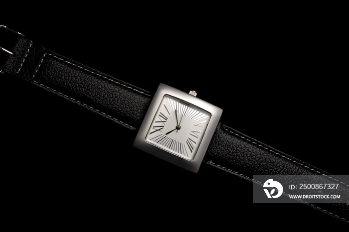 wrist watch with leather strap and on black background