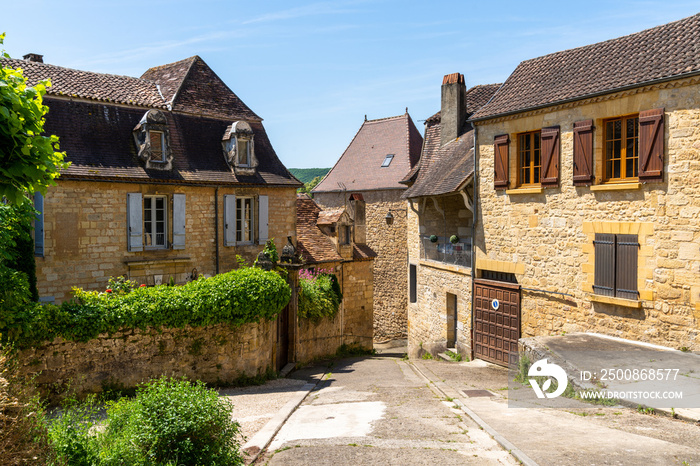 view of the historic village center of Saint-Cyprien with traditional brown stone houses