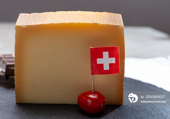 Block of Swiss medium-hard matured cheese gruyere used for baking, quiche, fondue, sandwiches