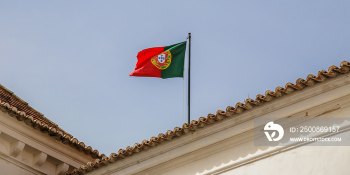 Portuguese flag waving on the Palace of Sintra, also called Town Palace (Palácio da Vila) located in the town of Sintra, in the Lisbon District of Portugal