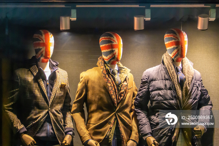 storefront with three male mannequins with British flag face