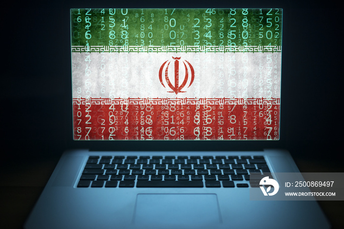 Iran internet and network security. Laptop with binary computer code and Iranian flag on the screen. Iranian hacker.