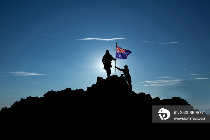 Two soldiers raise the Australian flag