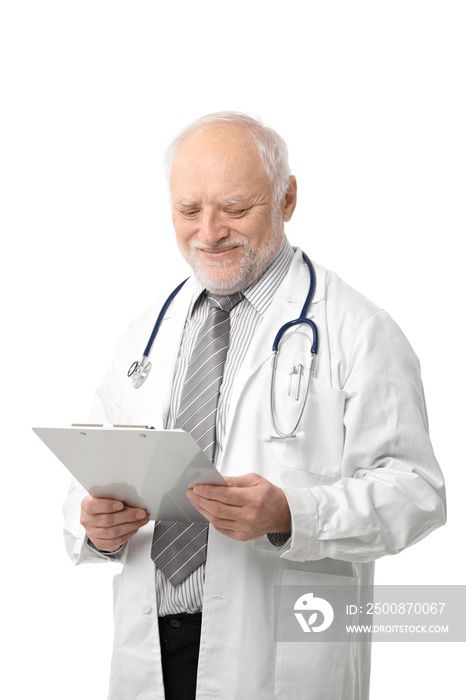 Portrait of senior doctor looking at papers, smiling, isolated on white.