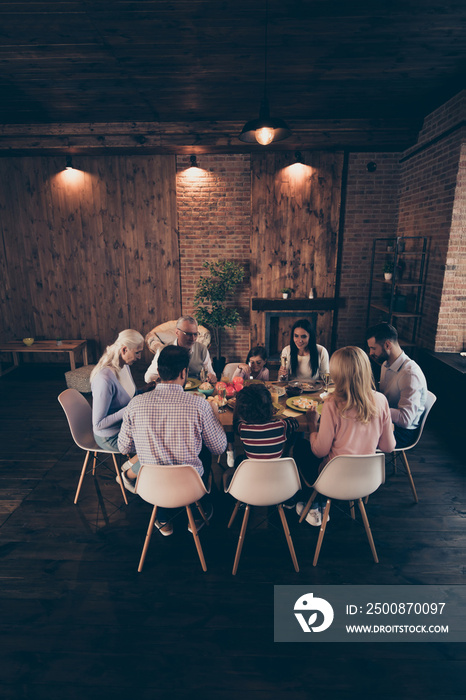 Vertical photo people big large family conversation communication cute atmosphere members company brother sister granny mom dad grandpa son daughter sit tasty dishes table loft house indoors