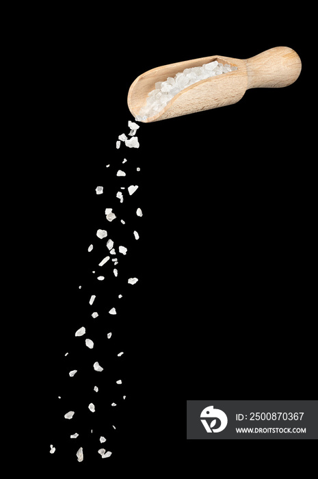 white sea salt falling from wooden spoon isolated