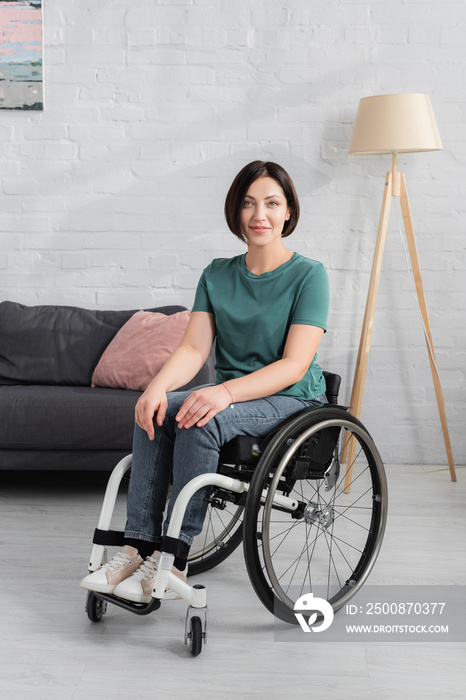 Disabled woman in wheelchair smiling at camera