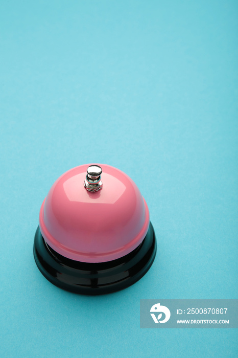 Pink service bell on a blue background.