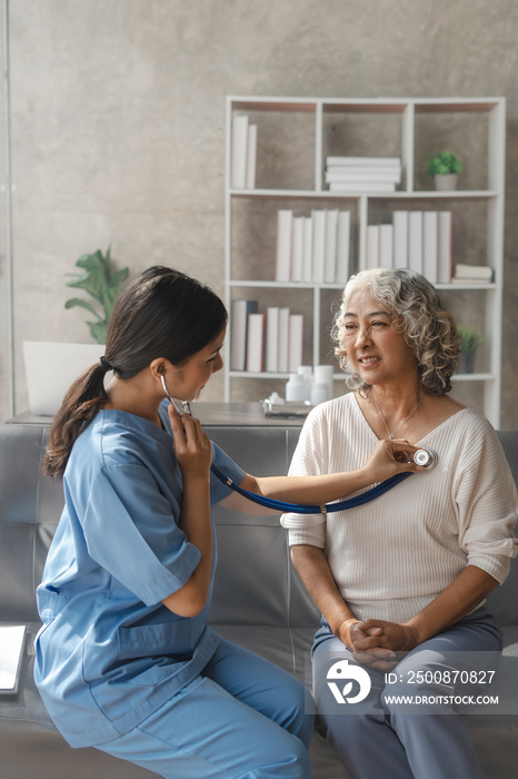 Young asian caretaker with 60s asia elderly woman consulting and encourage, take a history and recommend the right treatment, Use a stethoscope to listen to your heartbeat and check for abnormalities.