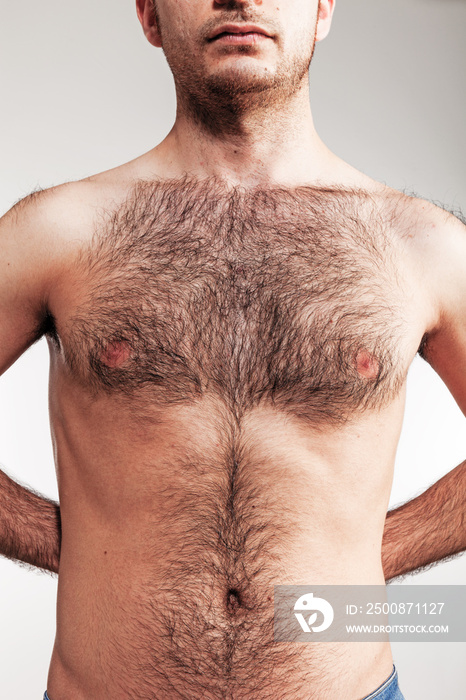 Boy with naked hairy chest on white background