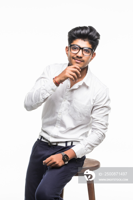 Portrait of indian young business man sitting on chair isolated on white background