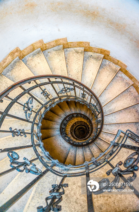 Antique stone spiral staircase in the tower of the bell tower of the Catholic Church