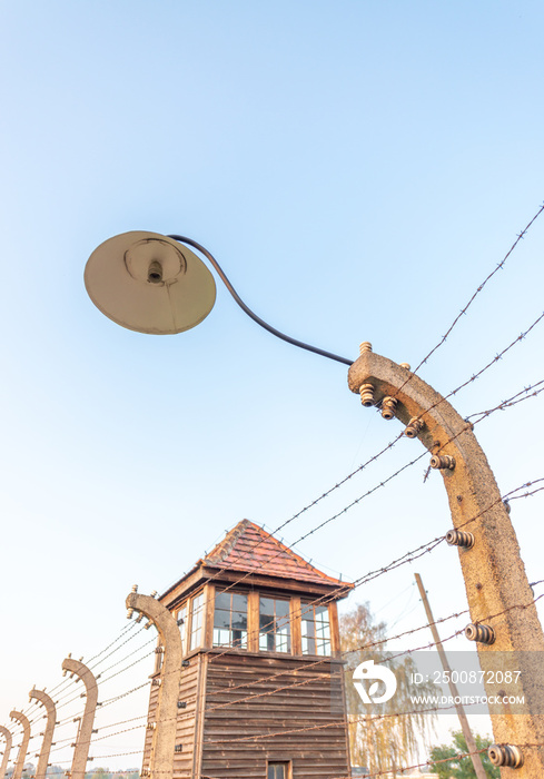 Electric fence with barbed wire in concentration camp Auschwitz-Birkenau in Oswiecim