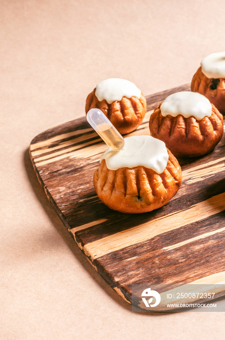 Soaked rum cake with white chocolate on a wooden cutting board