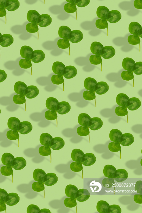 Clover leaf pattern on colored background. Abstract vertical background for St. Patrick’s Day