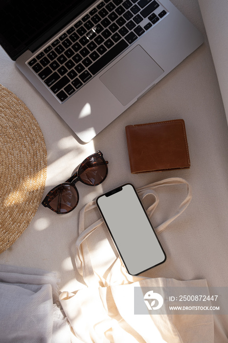 Flat lay mobile phone with blank mockup screen. Beautiful women’s fashion accessories in blurred sunlight shadows. Aesthetic lifestyle fashion influencer blog, magazine, social media