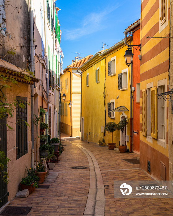 A pedestrian alleyway with colorful houses in the picturesque resort town of Cassis in  Southern France