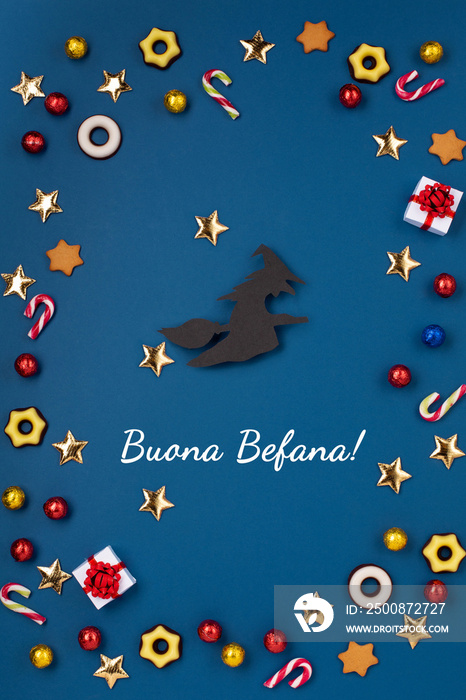 Italian Epiphany day concept. Witch Befana flying on broomstick, moon, stars and christmas sweets on dark blue background.