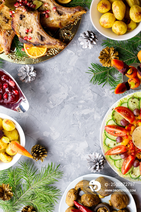 Christmas dinner with roasted meat steak, Christmas Wreath salad, baked potato, grilled vegetables, cranberry sauce.