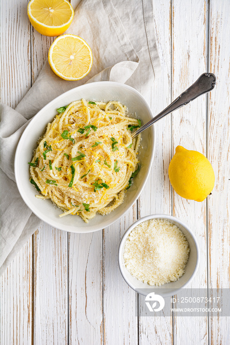 Pasta al Limone, delicious Italian meal, spaghetti with Parmesan, butter and lemon sauce, topped with fresh grated zest and cheese