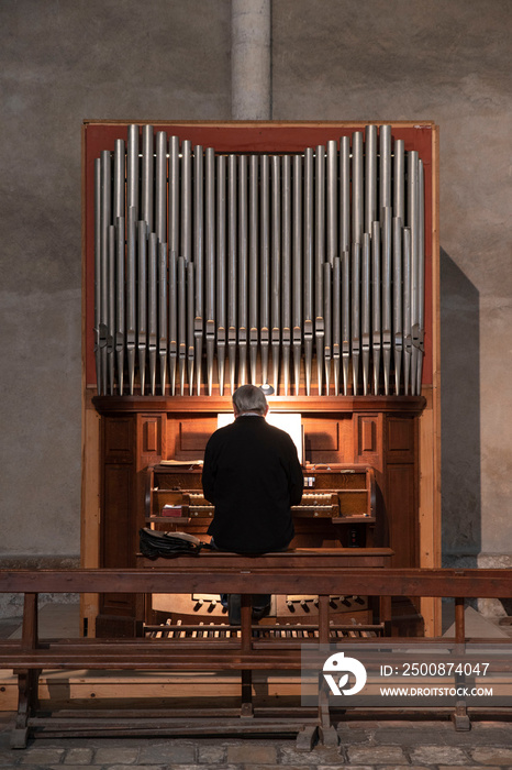 A man plays the organ in a church