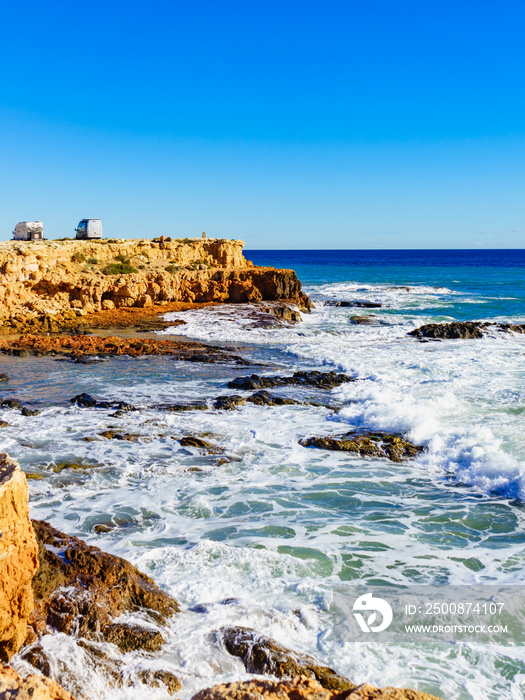 Coast in Spain, sea and campers on cliff