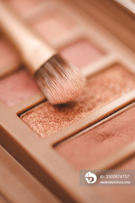 Eye shadow palette in pink rose gold and nude colors closeup. Makeup cosmetic product. Selective focus.