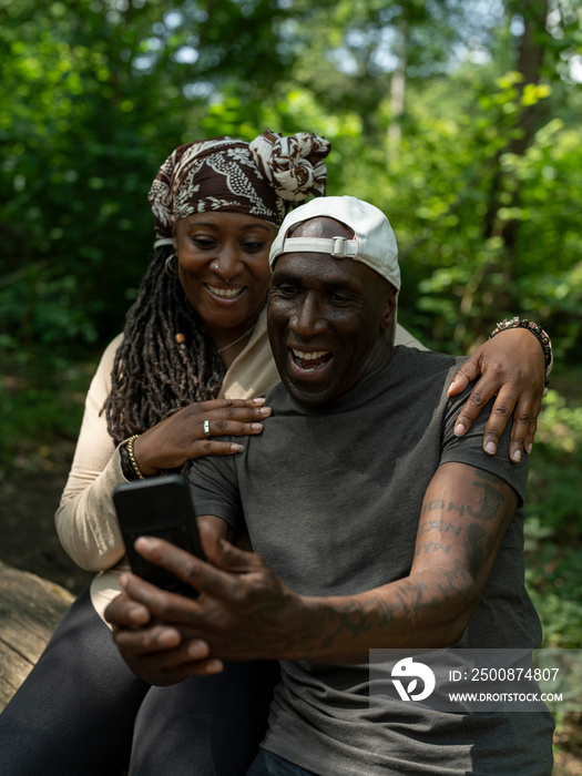 Smiling mature couple taking selfie on hike