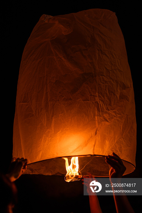 hands release sky lanterns (hot air balloon)Floating sky Lantern in northern Thai traditional new year , Yi Peng Festival and Loy Krathong festival