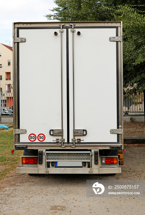 Back of closed lorry door on urban street