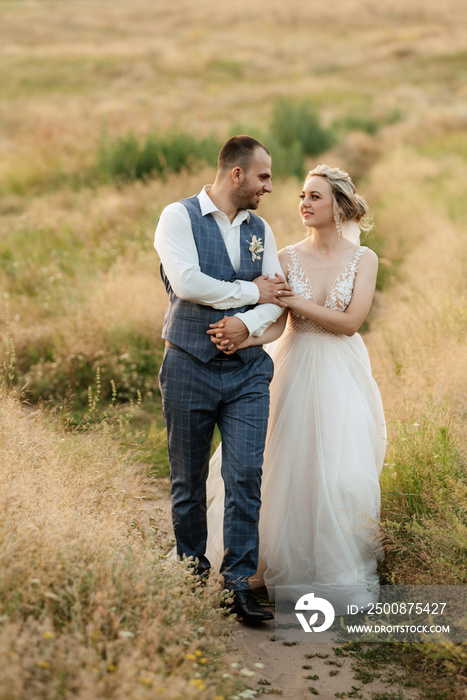 bride blonde girl and groom in a field