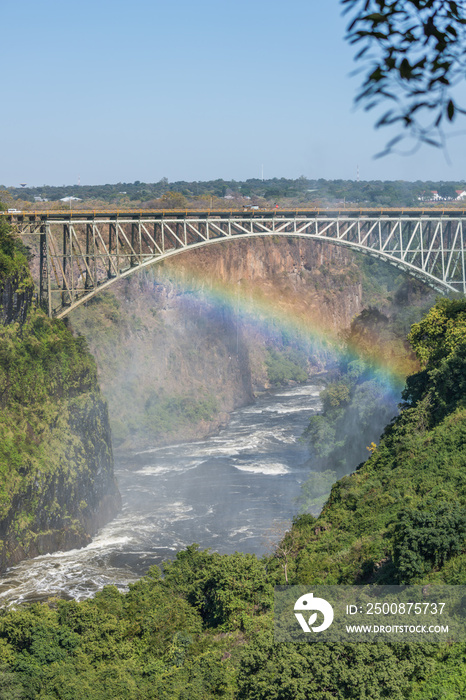 Rainbow crossing gorge beneath Victoria Falls Bridge