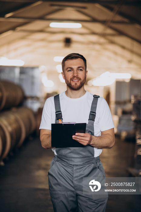 Young handsome man working at a factory